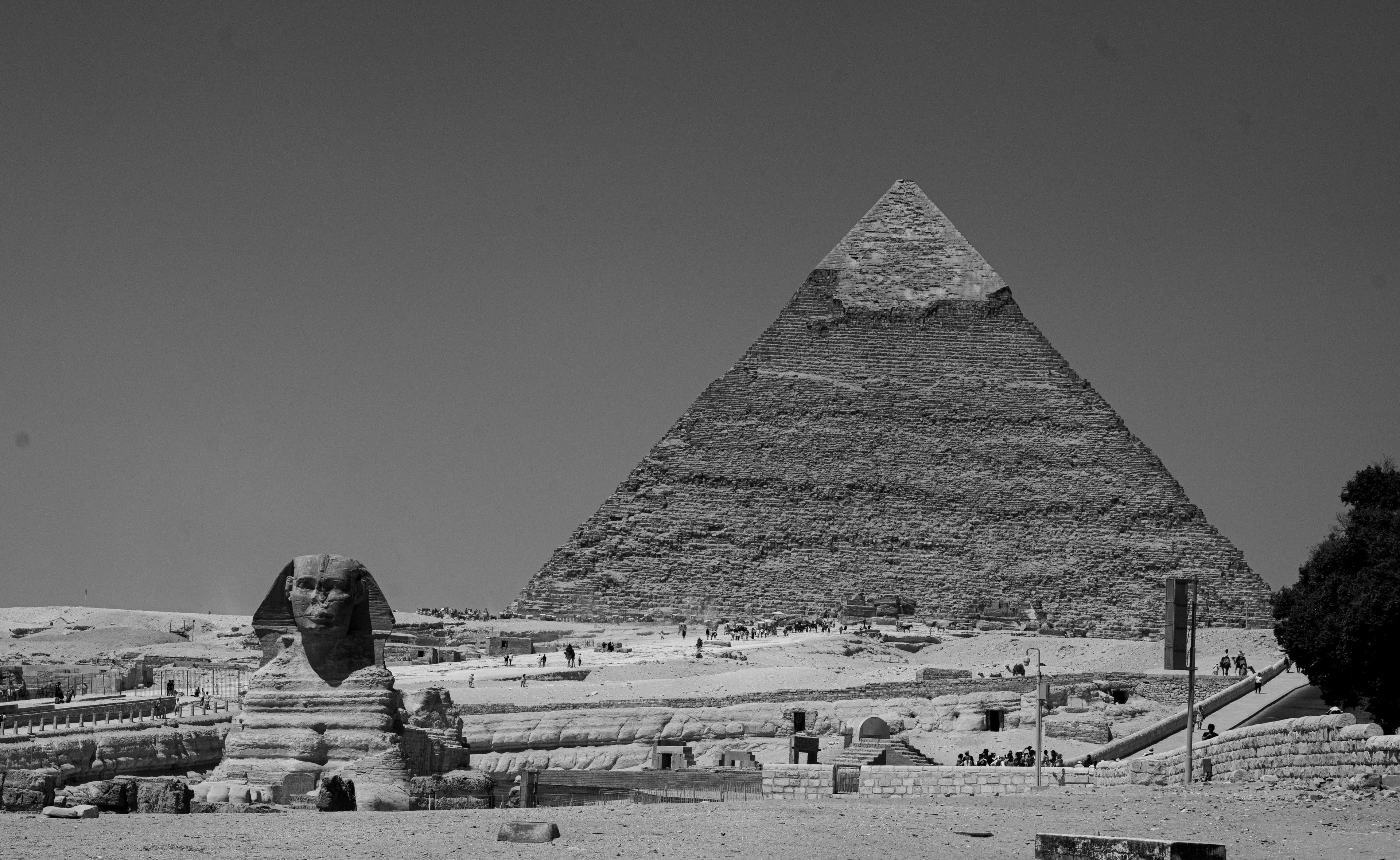 Black-and-white photograph of the Great Pyramid and the Sphinx in Egypt.