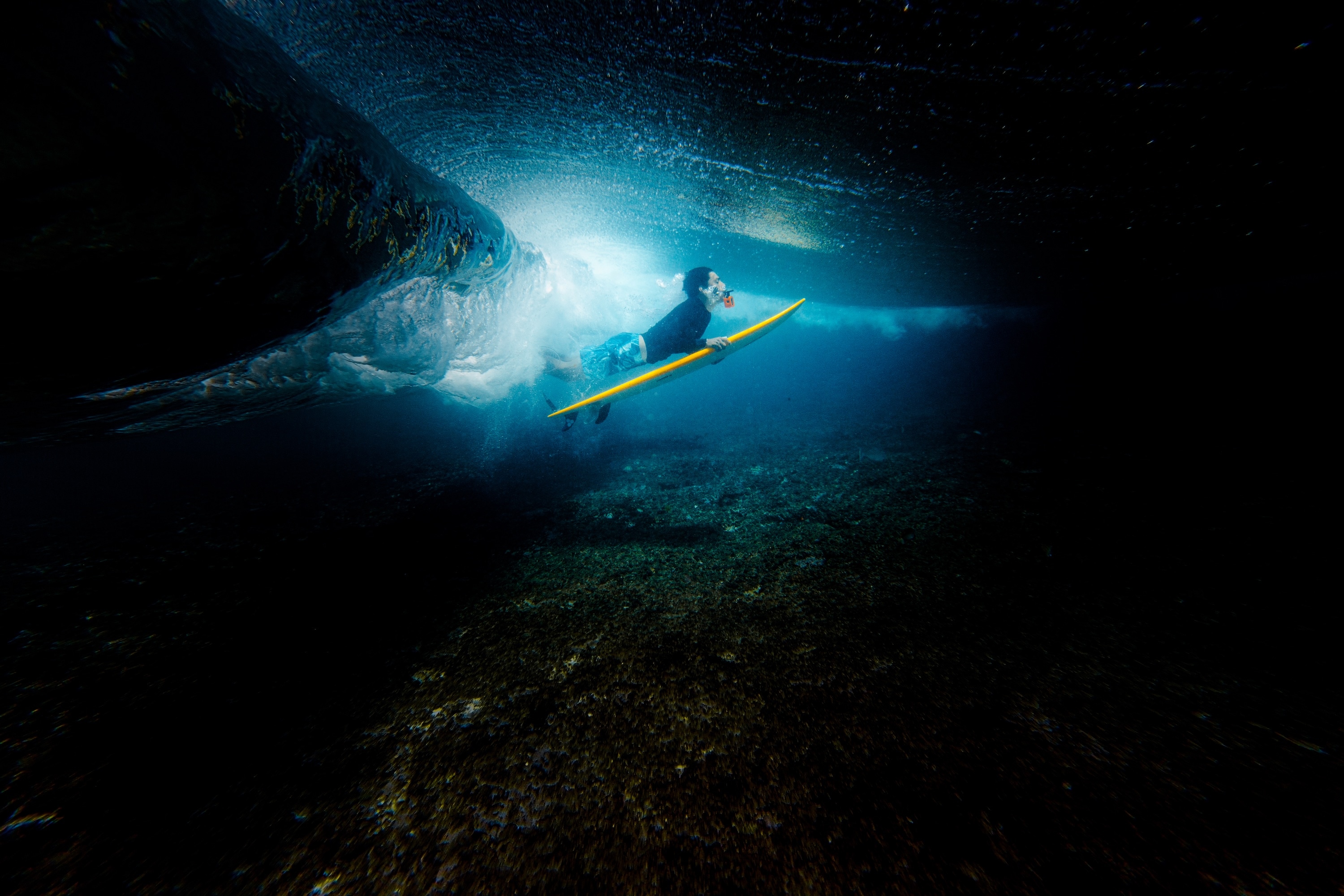 Surfer duckdive in the Maldives